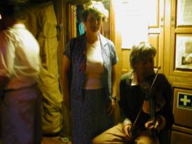 Visitors with wax figure of fiddler